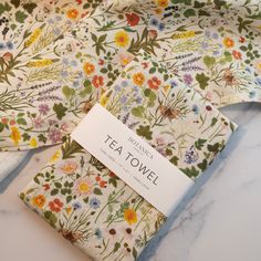 three tea towels with floral designs on them