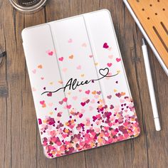 an ipad case with hearts on it and the word alive written in cursive writing