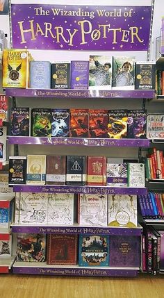 there is a display in the store with many books on it and one sign that says, the wizarding world of harry potter