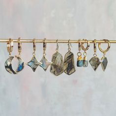 Embrace the magic of labradorite with our exquisite collection of earrings that shimmer with flashes of blue, green, and gold. Each piece is designed to capture the enchanting qualities of this gemstone, making every pair truly unique. 🌙 Labradorite Crescent Moon Huggies: These crescent-shaped earrings showcase the striking iridescence of labradorite, with hues that shift as they catch the light. Perfect for those drawn to the moon's mystique, these earrings will add a celestial glow to any outfit. ⭐ Star Drop Earrings: Faceted labradorite stones cut into star shapes offer a playful yet refined way to add a bit of sparkle to your look. The interplay of colors in the stone reflects the beauty of the night sky. 💎 Geometric Statement Drops: Bold, faceted labradorite stones in geometric shap Earring Stack, Labradorite Earrings, Labradorite Stone, Stone Cuts, Earrings Collection, Star Shape, Crescent Moon, Green And Gold, Geometric Shapes