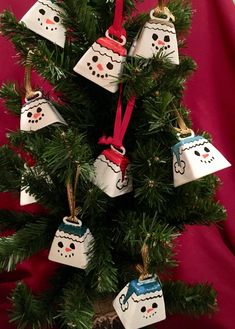 a christmas tree with snowmen hanging from it