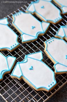 cookies decorated with blue and white frosting on a cooling rack