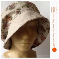 a white hat with flowers on it sitting on top of a mannequin head