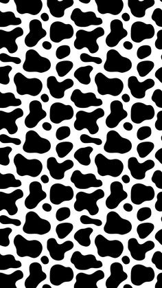 a black and white animal print pattern that looks like it has spots on the surface