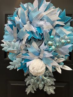 a blue and silver wreath on the front door