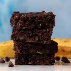 three brownies stacked on top of each other in front of a yellow and blue background