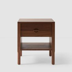 the side table is made out of wood and has a drawer on one side, with an open drawer at the top