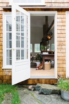 an open door to a small wooden house