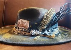 Custom Handpainted Hat Artist Created  Gold and Black  Feather Accent Crystal Card  Says The Gold That Glitters  One of a Kind  yellowstonegypsyhats.com Black Feathers, Hat Band, The Gold, Best Seller, Cowboy Hats, Caps Hats, Oregon, Accessories Hats, Cowboy