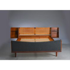 a bed with a wooden headboard and foot board in the shape of a couch