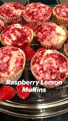 some raspberry cupcakes are on a glass plate