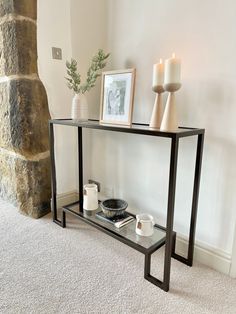 a glass table with some candles on it