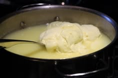 a pot filled with cream sitting on top of a stove