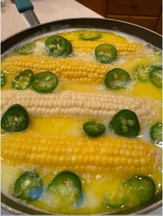 corn on the cob with peppers and jalapenos in a skillet