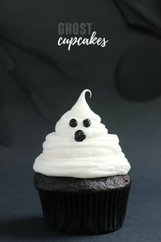 a cupcake with white frosting and spooky eyes