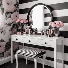 there is a vanity with flowers on the wall and a stool in front of it