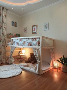 a child's bedroom with a bunk bed and teddy bear on the bottom floor