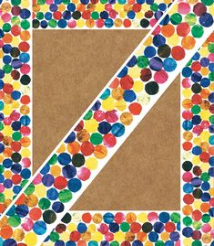 the letter k is made up of circles and dots on brown paper with a white border