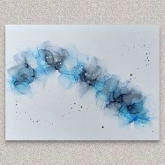 an abstract painting with blue and black colors on a white background, it looks like something out of space