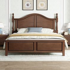 a bedroom with a bed, nightstands and two pictures on the wall above it