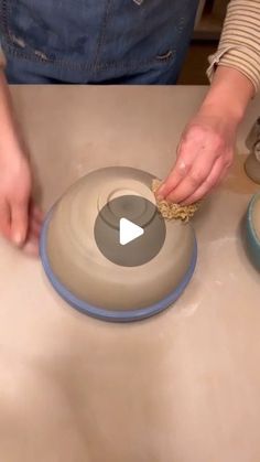 a woman is using a bowl to clean the dishes