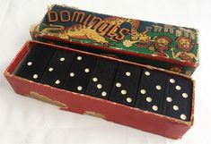 an old domino game in its box on a white surface