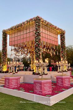 an outdoor stage decorated with flowers and candles