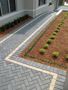 a brick walkway in front of a house