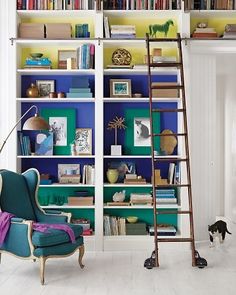 a ladder leaning up against a bookshelf in a room with blue and green walls