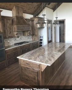 a large kitchen with wooden cabinets and marble counter tops