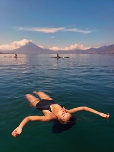 a woman floating on top of a body of water