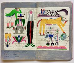 an open notebook with drawings on it and writing in the pages, which are colored