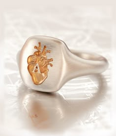 Initial unisex Chevalier Ring. We will make it with your initial. Silky satin finish with warm golden details, comfort fit inside, so you won't want to take it off! Perfect gift for any occasion. About this item: -Solid 925 Silver -Gold plating -Engraved heart detail Please allow up to 2-3 weeks for production, as each item is made to order. You may also like: https://www.etsy.com/listing/795434381/heart-ring-heart-engraved-signet-heart?ref=shop_home_active_14&frs=1 https://www.etsy.com/list Luxury Heart-shaped Elegant Signet Ring, Unique Polished Signet Ring For Anniversary, Heart-shaped Sterling Silver Engraved Signet Ring, Heart-shaped Engraved Ring As Gift, Heart-shaped Engraved Sterling Silver Signet Ring, Heart-shaped Engraved Ring Polished Finish Gift, Heirloom Heart Ring With Polished Finish As Gift, Ring Initial, Gold Heart Ring