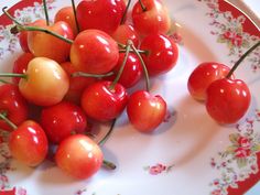 some cherries are sitting on a plate