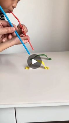 two children are playing with toothbrushes on the table