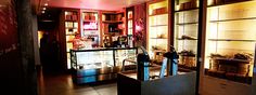 the inside of a store with lots of shelves and items on display behind glass doors