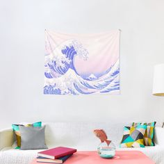 a living room with a couch, coffee table and wall tapestry