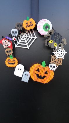 a beaded halloween wreath with pumpkins and ghostes