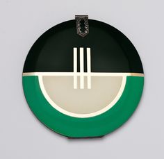 a green and white plate with two forks on the side, hanging from a chain