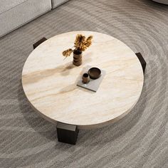 a coffee table sitting on top of a carpeted floor next to a white couch