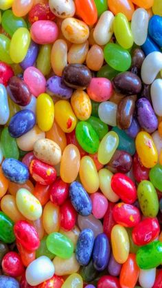 many different colored candy beans are scattered on top of each other