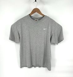 For sale is a vintage 1990s Nike T shirt 90% cotton/ 10% poly - Made in USA Tagged size Medium Measures 21.5'' Pit to pit across chest 28'' Length on back Good vintage condition, gently worn with no past signs of wear. Shipped safely and securely See my 100% positive feedback ! Fitted Gray Sportswear T-shirt, Gray Sportswear T-shirt, Gray Vintage T-shirt With Text Print, Nike Gray Sports T-shirt, Nike Collegiate Moisture-wicking T-shirt, Nike Vintage, Nike T, Shirt Nike, 90s Mens