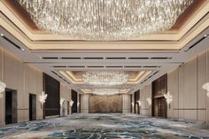 an empty ballroom with chandeliers and large carpeted flooring in the middle