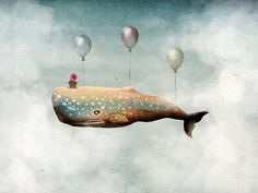 a whale floating in the air with balloons attached to it