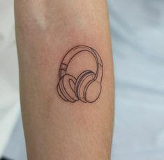 a black and white photo of a person's arm with headphones on it