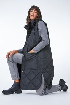 Diamond Quilted Longline Gilet from Roman. Stylish layering has never been more simple with this Roman quilted longline gilet! Designed with a warm high neckline, this casual coat is sure to see you through Autumn and Winter in style. This gilet is crafted with a drawstring hood, fully lined body and diamond quilted design to ensure a flattering and functional fit. It features popper-fastened pockets at the front for all of your essentials. Pair with cosy knitted jumpers, jeans and boots for dog walks and family day trips this season. Hooded Gilet, Frills And Ruffles, Evening Tops, Oasis Fashion, Petite Tops, Style Cardigan, Diamond Quilt, Casual Coat, Fashion Face