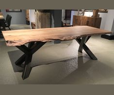 a wooden table sitting on top of a gray floor