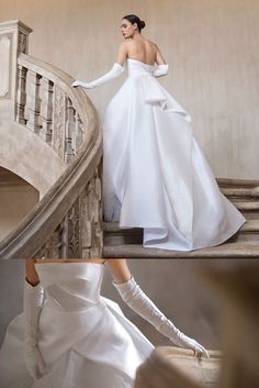 a woman in a white dress is walking down the stairs