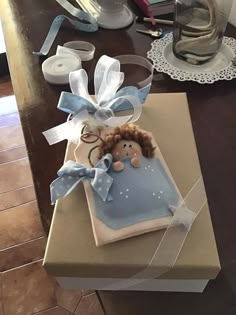 a cake shaped like a baby in a box on a table next to other items