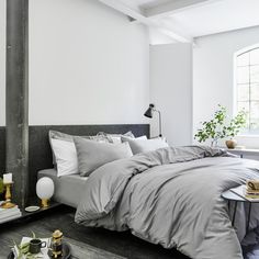 a bed sitting in a bedroom next to a table with a tray on top of it